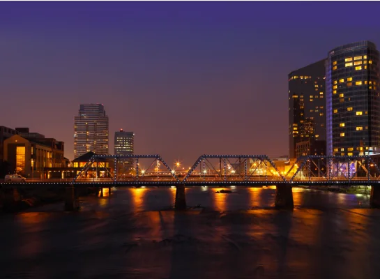 A Michigan river bridge lit at dusk